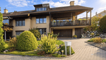 2 story house, brown roof, beige walls, balcony, driveway, garden, garage