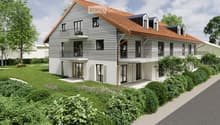 Modern two-story house with a red roof, white walls, and multiple windows. The house has a balcony on the second floor and is surrounded by greenery.