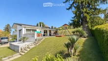 Detached house, white exterior, large garden, swing, car parked, steps leading to entrance