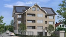 3 story apartment house, solar panels on the roof, driveway