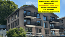 Modern multi-story residential building with balconies, large windows, and a contemporary design.