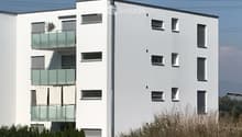 white exterior, glass balcony railings, multiple windows, 5 stories