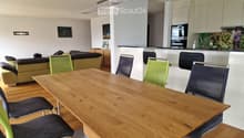 large table, modern chairs, modern kitchen island, hanging lamp, modern artwork