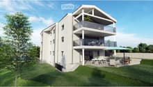 Modern two-story house with white exterior, multiple balconies, and outdoor patio furniture.