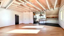 {"visible_features": [],    "type": "Room",    "description": "Open kitchen with modern appliances, wooden floors, white walls, wooden beams, refrigerator, cabinets, central island with sink and stove",    "localized_descriptions":        {        "E