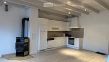 kitchen with white cabinets, wooden floor, fireplace, modern appliances