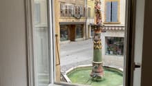 View from window showing a fountain in a street outside