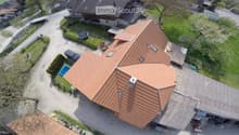 Modern two story house, red roof, outdoor swimming pool