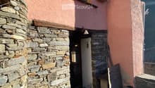 Stone wall, wooden door, window, lamp, bench, stone floor