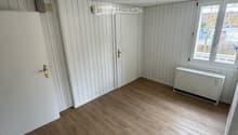 empty room, white walls, wooden floors, windows, wooden doors, light fixture