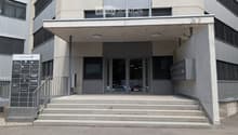 Modern building entrance with concrete steps, glass doors, and a sign displaying "Talstrasse 37".