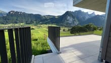 Balcony with tiled floor, wooden railing, and scenic mountain view.