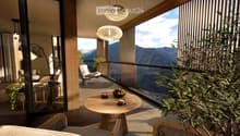 Balcony with wooden table, chairs, bowl of fruit, and a view of mountains.