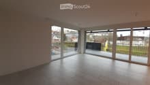 Empty room with large sliding glass doors leading to a balcony, tiled floor, and bright natural light.