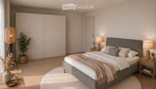 Modern bedroom with a large bed, nightstands, lamps, a round rug, and decorative plants and vases.