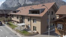 3 story house, brown roof, multiple balconies, windows, street view