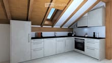 Modern kitchen with white cabinets, stainless steel appliances, and a black countertop. Features include a refrigerator, oven, toaster, and decorative vases.