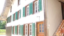 two story house, wooden door, wooden stairs, wooden railing, green shutters, white walls, windows