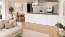 Open-plan living and dining area with a light-colored sofa, coffee table, dining table, and modern kitchen featuring white cabinets and stainless steel appliances.