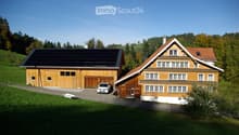 Two-story wooden house with a garage, solar panels on the roof, and a parking area.