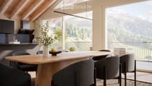 Modern dining area with a large wooden table, grey upholstered chairs, a vase with greenery, and a bowl of fruit. The space features exposed wooden beams, large windows with a scenic mountain view, and contemporary kitchen elements.