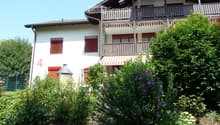 2 story house, white exterior, red shutters, balcony, red awning, garden, number 4