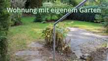 Garden with lawn, pathway, plants, bushes, stone step, railings