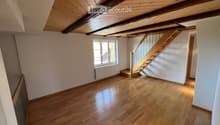 empty room, wooden floor, wooden ceiling, white walls, window, radiator, staircase