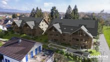 Aerial view, modern house design, raised ground floor, terrace, large windows, multiple balconies, green landscaping, solar panels, distant mountain view