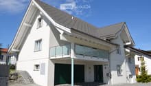 modern white house, gray roof, glass balcony, garage, paved driveway