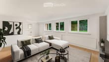 Modern living room with white walls, large windows, grey sectional sofa, coffee table, and decorative plants.