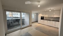 living room, open floor plan, kitchen, large sliding glass door, balcony, white cabinets, tiled floor