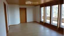 empty room, hardwood floors, wooden ceiling, large windows, balcony with view