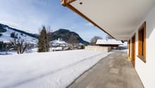 covered terrace with snow, stone flooring, mountains in background