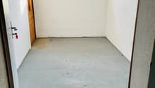 empty room, white walls, wooden floor, small window, door on left
