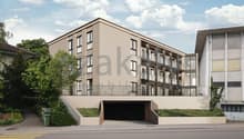 4-story apartment building with a garage entrance on the ground floor, balconies, and a modern, beige exterior design.