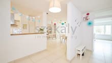 white walls, white tile flooring, white ceiling, white bench, white shelf, decorative items, hanging lamp, open door