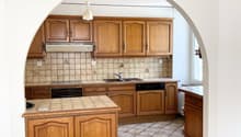 modern kitchen, wooden cabinets, tiled floor, sink, dishwasher, microwave, refrigerator