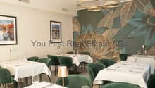 Eleganter Restaurantbereich mit hohen Decken und moderner Beleuchtung