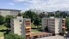 Large apartment complex with a parking lot
