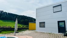 modern style house with large windows, yellow garage, small swimming pool