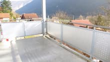 concrete floor, metal railing, view of mountains
