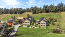 Collection of 6 modern buildings set on a grassy hillside