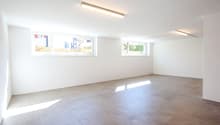 empty room, white walls, tiled floor, three windows, artificial lighting