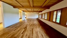 empty room, wooden floor, wooden ceiling, white walls, windows