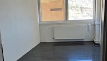 empty room, white walls, black floor, white radiator, window