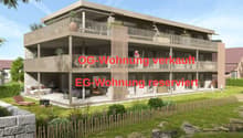 3-storey apartment building with a ground-level terrace and balconies on the first two floors.