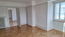 empty room, wooden parquet floor, white walls, open door, radiator, windows