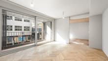 empty room, wooden parquet floor, large glass doors, balcony, white walls