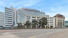 large building, glass windows, modern architecture, trees, street lights, large road
